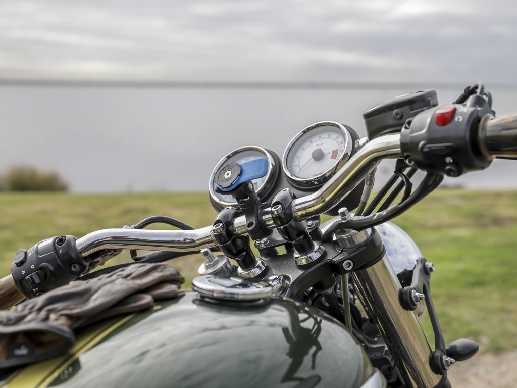 triumph bike with quad lock handlebar mount and motorcycle knuckle adaptor